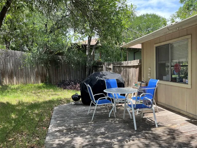 a view of a chairs and table in backyard of the house