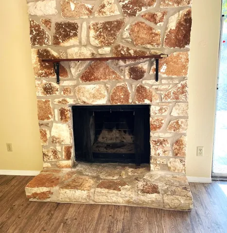 a view of fireplace with wooden floor