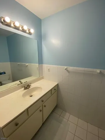 a bathroom with a sink vanity and a mirror