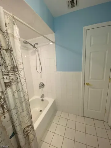 a bathroom with a bathtub and shower