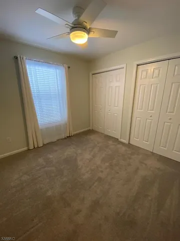 an empty room with windows and entrance