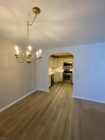 a view of a room with wooden floor