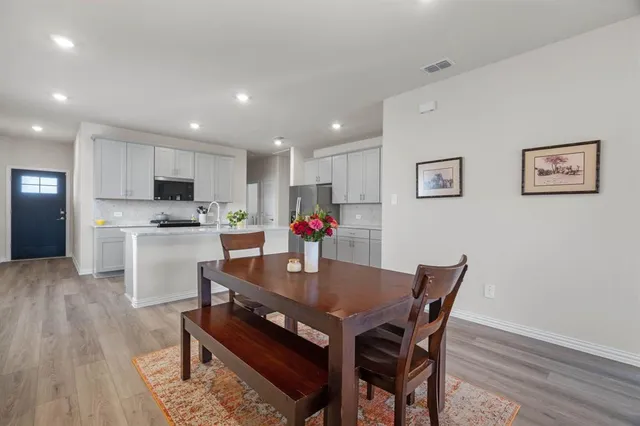 a kitchen with granite countertop a sink stove and refrigerator