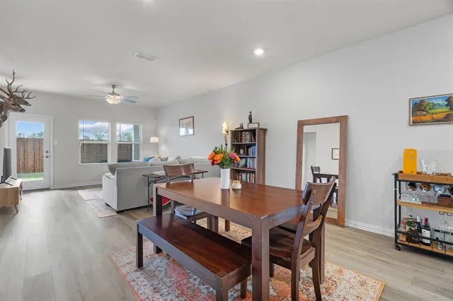 a kitchen with kitchen island granite countertop stainless steel appliances lots of counter space dining table and chairs