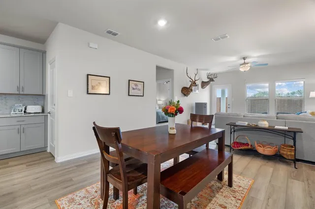 a view of a dining room with furniture and wooden floor