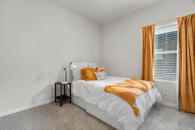 a en suite bathroom with a double vanity sink and a mirror