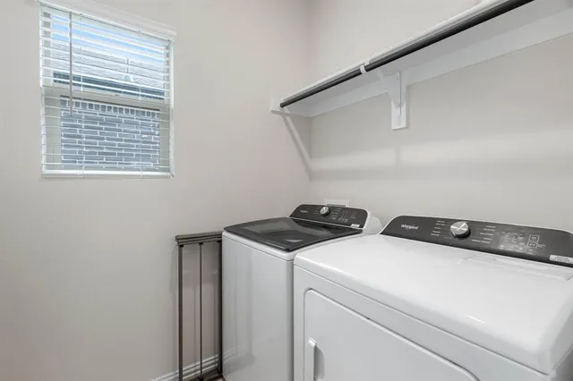 a bathroom with a sink a toilet a mirror and shower curtain