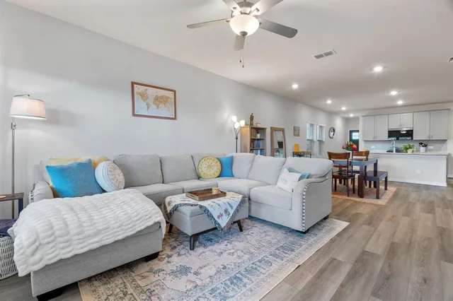 a living room with furniture and kitchen view