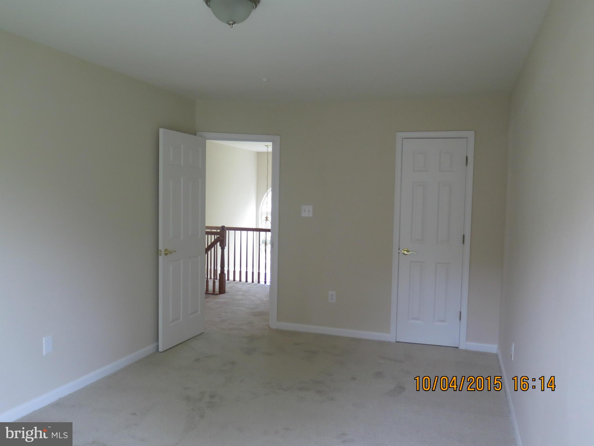 8506 Topaz Court Clinton, MD 20735 - Photo 19 of 30 an empty room with wooden floor and windows