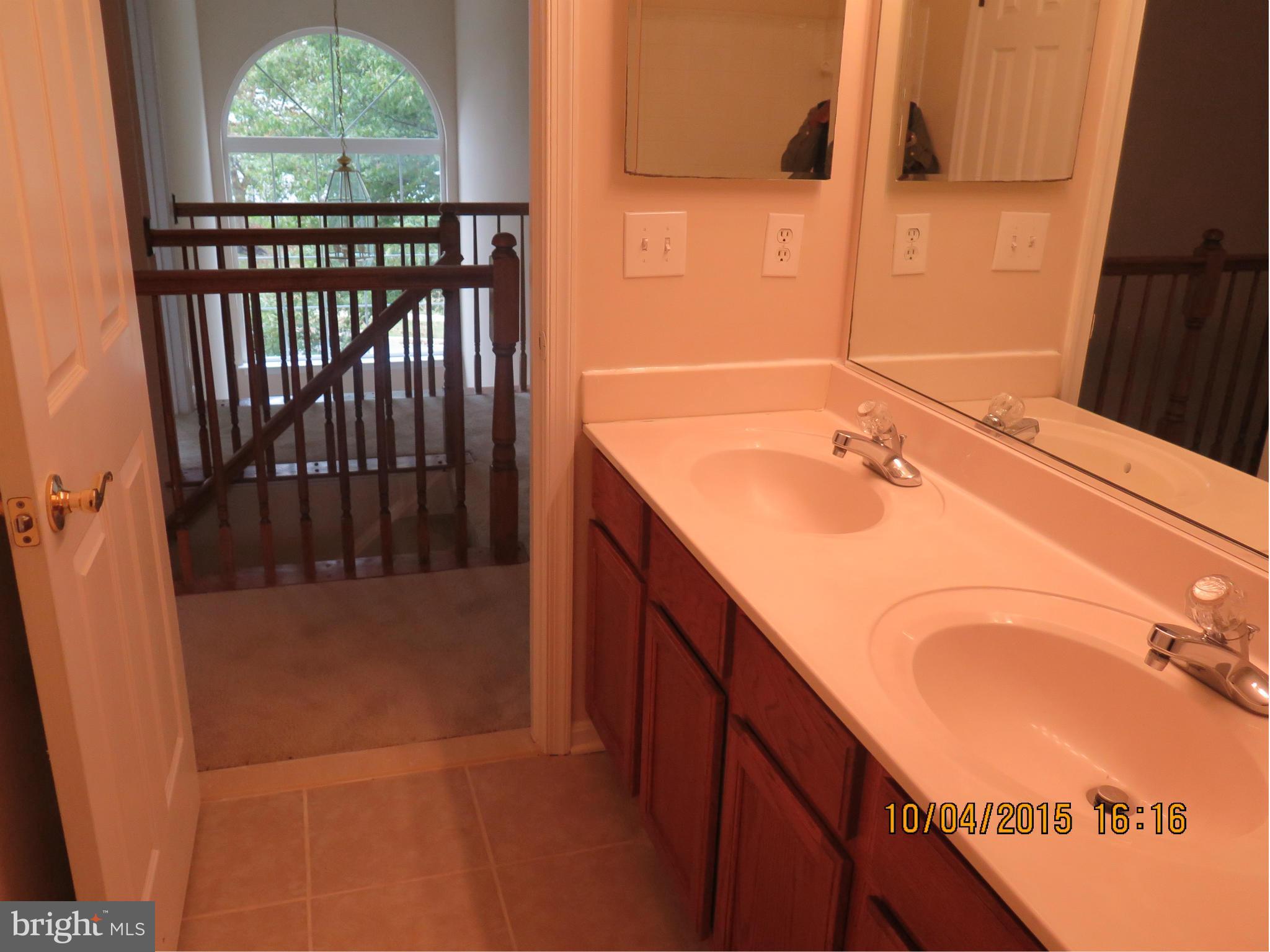 8506 Topaz Court Clinton, MD 20735 - Photo 23 of 30 a bathroom with a sink and a mirror