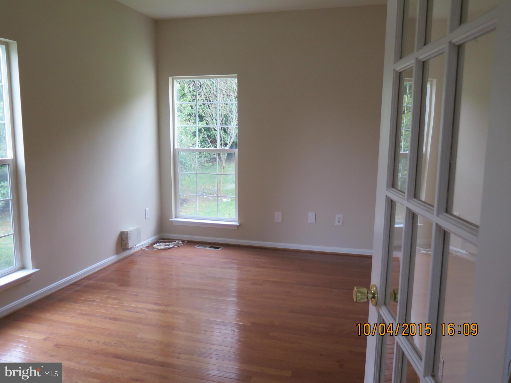 8506 Topaz Court Clinton, MD 20735 - Photo 6 of 30 a view of an empty room with wooden floor and a window