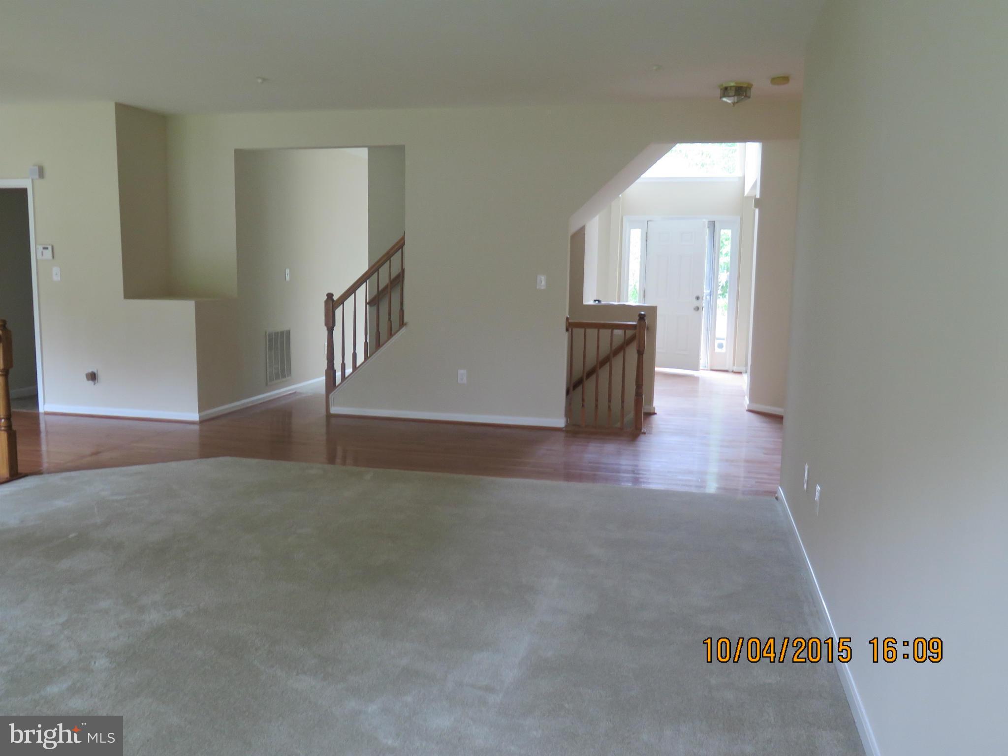 8506 Topaz Court Clinton, MD 20735 - Photo 8 of 30 a view of empty room with stairs and wooden floor