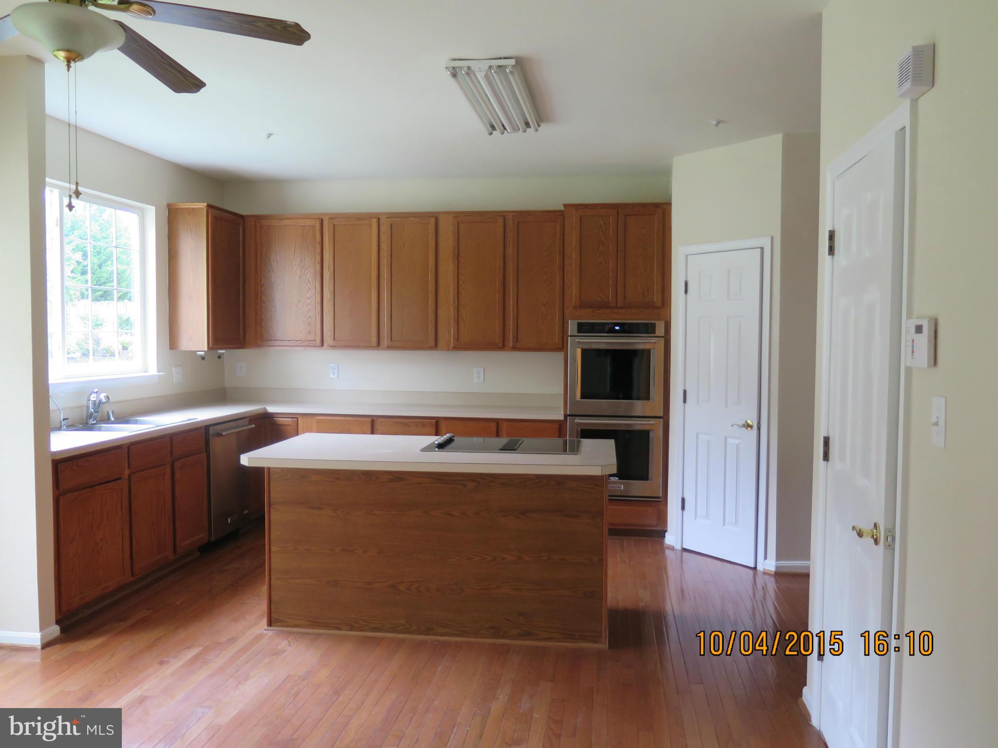 8506 Topaz Court Clinton, MD 20735 - Photo 10 of 30 a kitchen with stainless steel appliances granite countertop a stove a sink and a refrigerator
