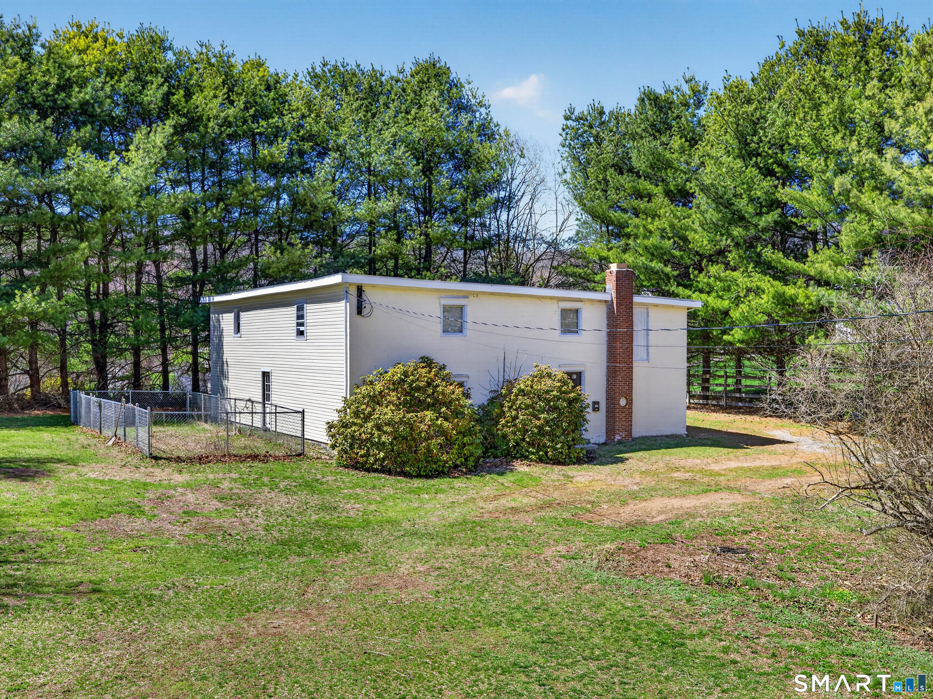 1092 Durham Road Guilford, CT 06437 - Photo 22 of 61 a view of a back yard with flower plants and large tree