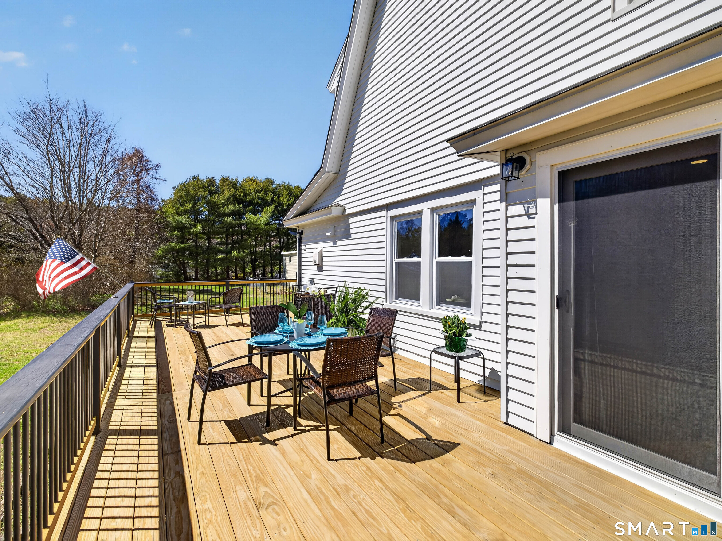 1092 Durham Road Guilford, CT 06437 - Photo 35 of 61 a view of a patio with dining table and chairs with wooden floor and fence