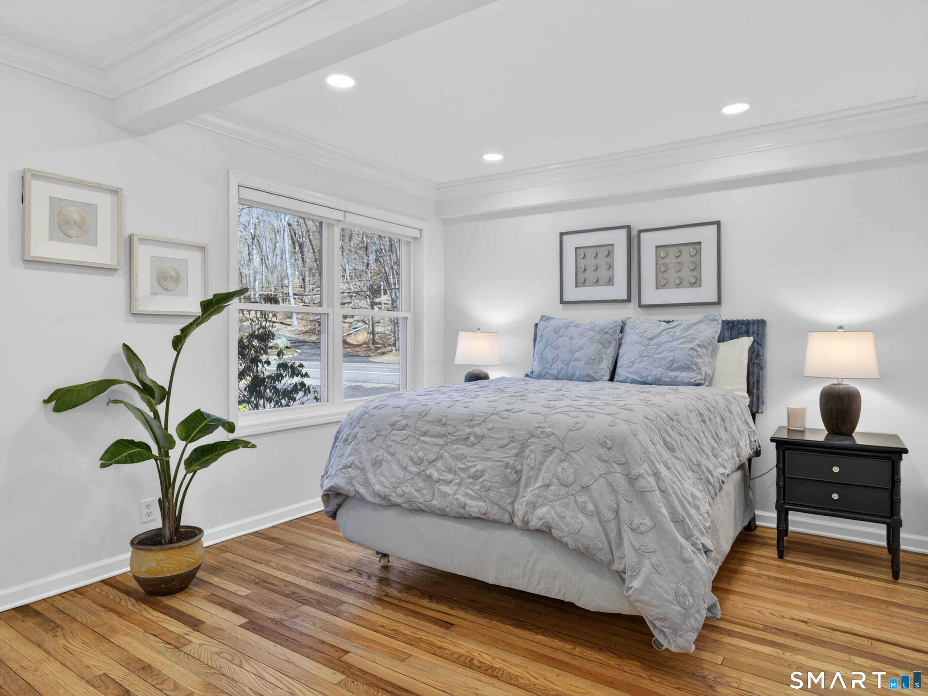 1092 Durham Road Guilford, CT 06437 - Photo 45 of 61 a bedroom with a large bed and a potted plant