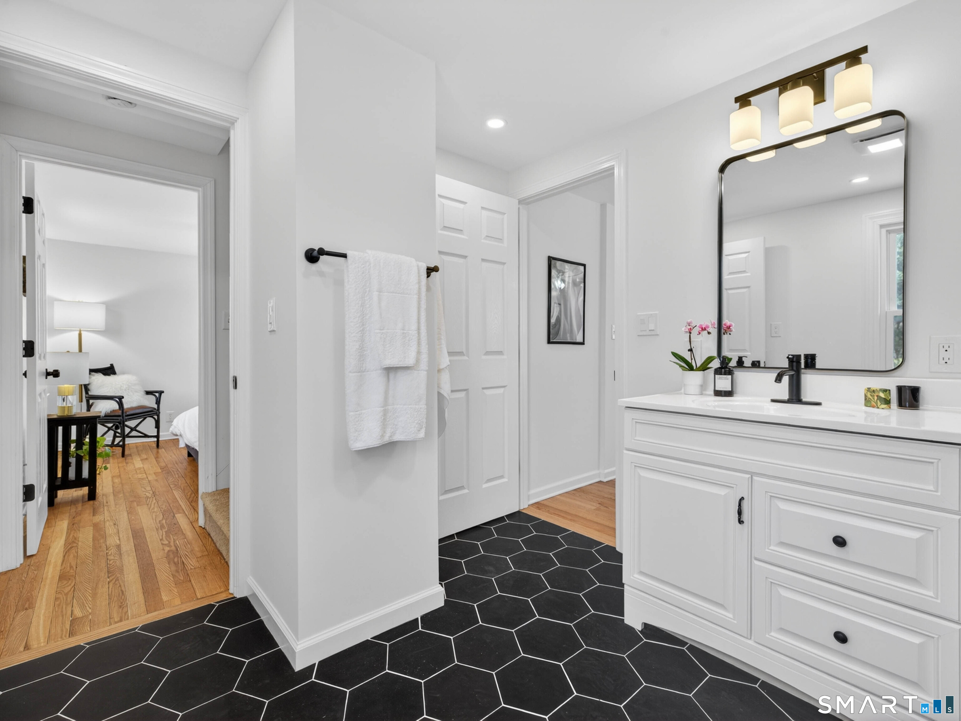 1092 Durham Road Guilford, CT 06437 - Photo 49 of 61 a spacious bathroom with a double vanity sink a mirror and shower
