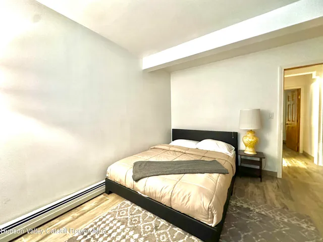 a bedroom with two beds and a potted plant