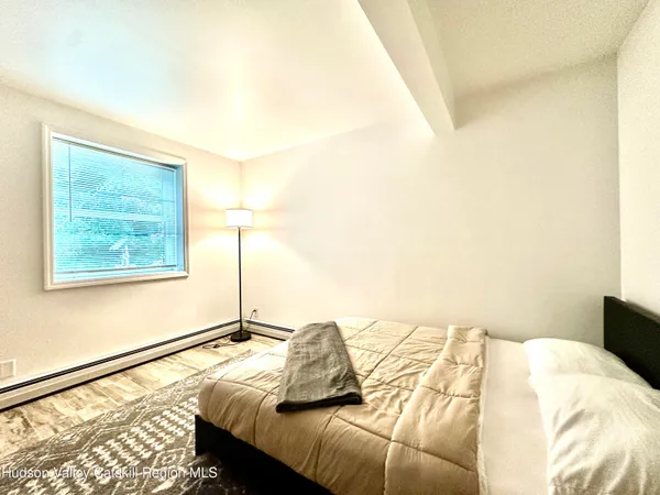 a bed sitting in a bedroom next to a window