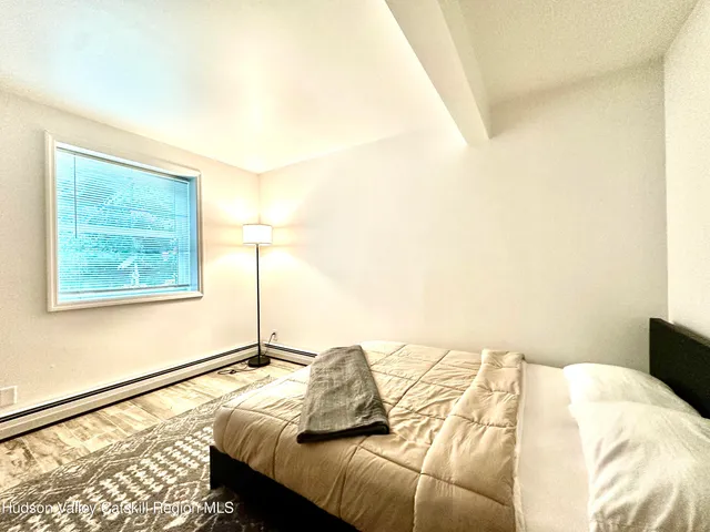 a bed sitting in a bedroom next to a window