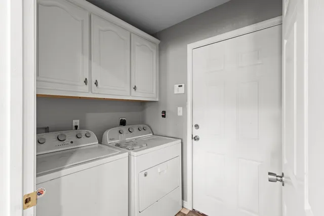 a view of cabinets with washer and dryer