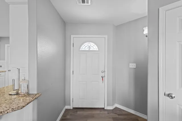 a view of an entryway with wooden floor