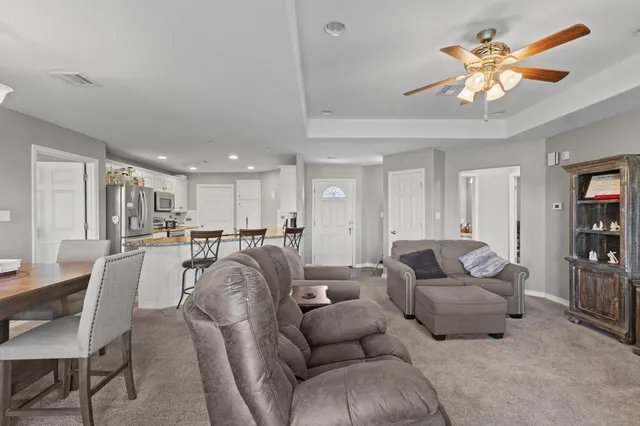 a living room with furniture and a chandelier
