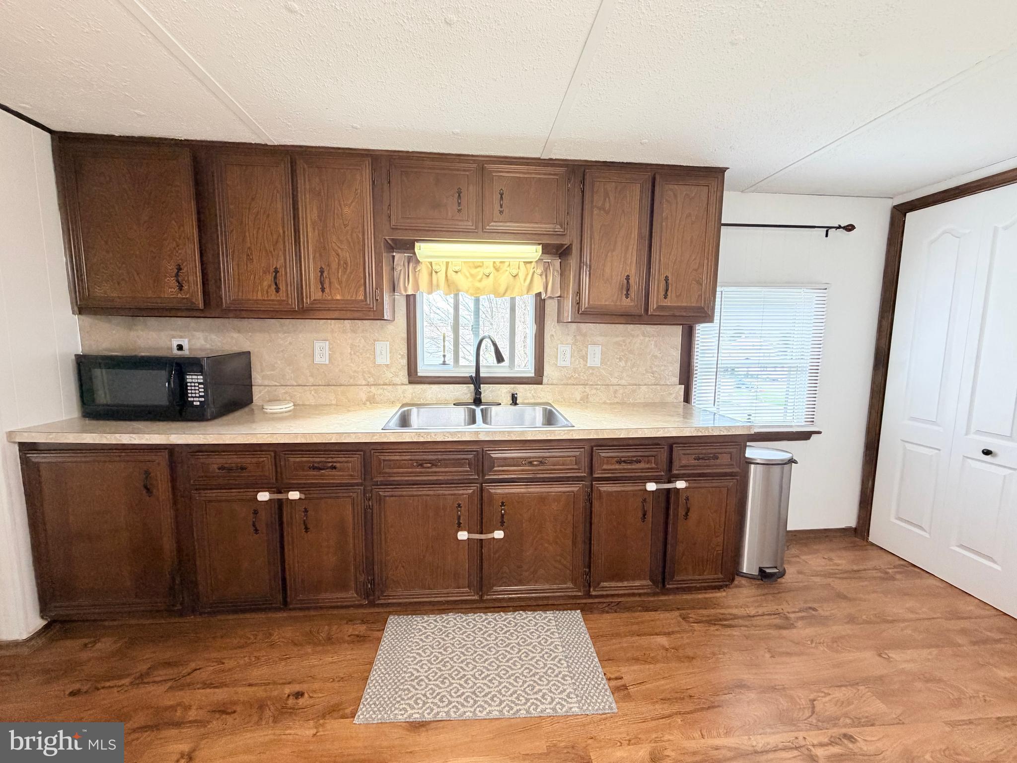 217 Oak Street Wiconisco, PA 17048 - Photo 16 of 31 a kitchen with granite countertop a sink cabinets and wooden floor