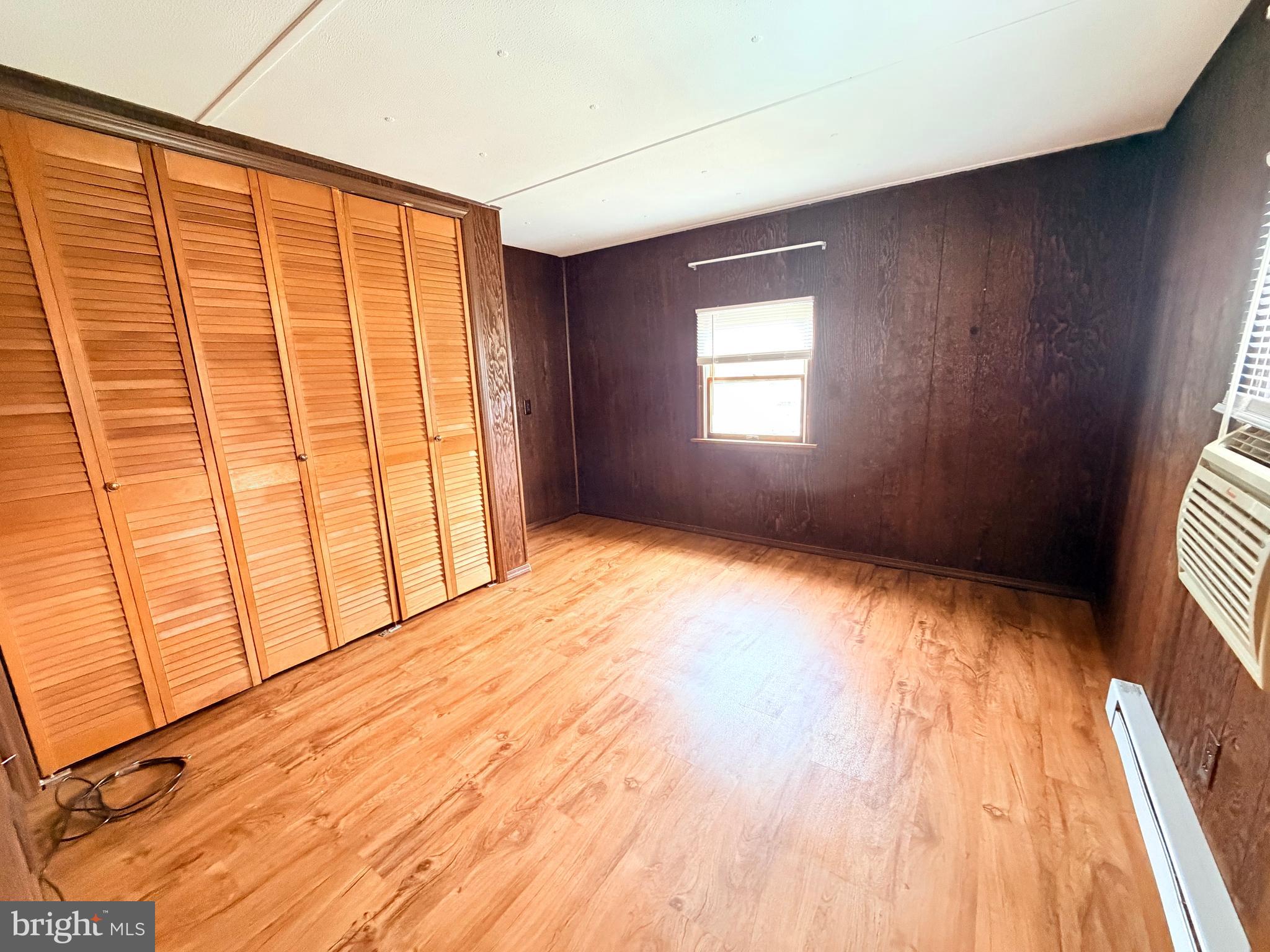 217 Oak Street Wiconisco, PA 17048 - Photo 22 of 31 a view of an empty room with a window and wooden floor