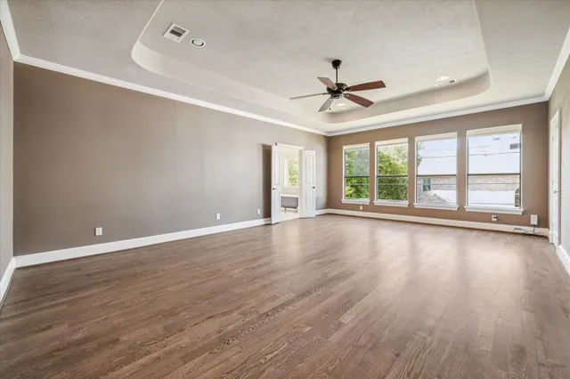 wooden floor in an empty room with a window