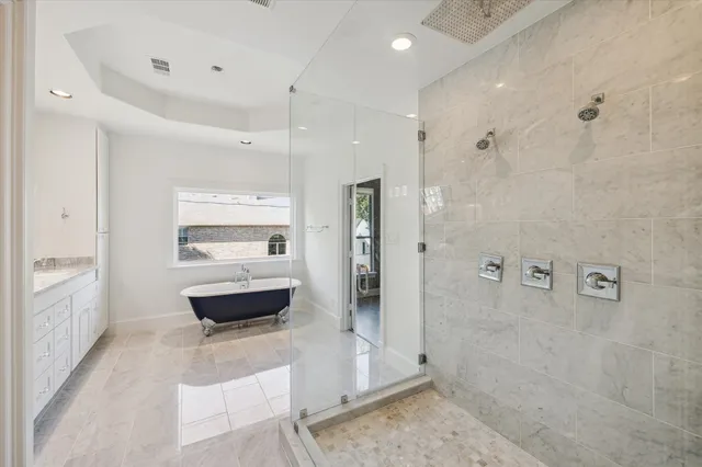 a bathroom with a glass shower door and a sink