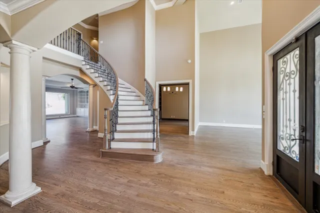 a view of entryway and hall with wooden floor