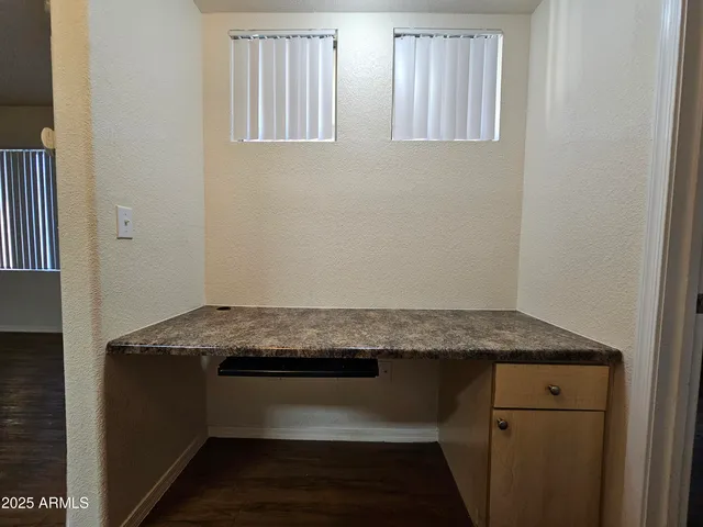 a room with granite countertop cabinets and sink