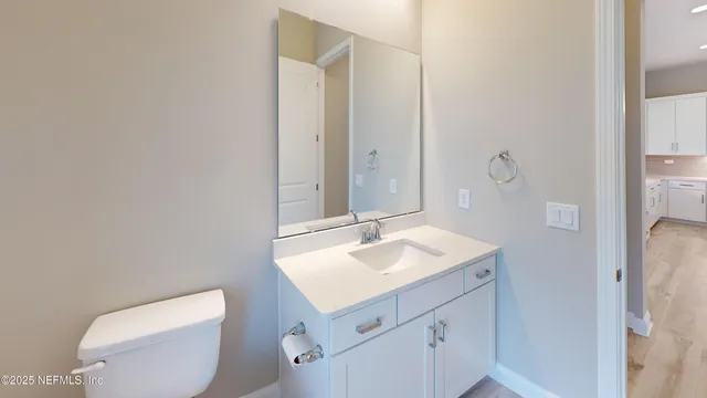 a bathroom with a sink toilet and mirror