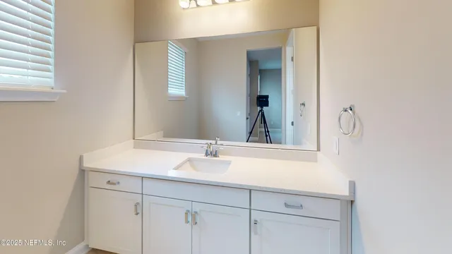 a bathroom with a sink and a mirror