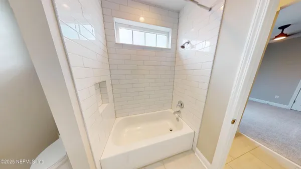 a bathroom with a bathtub a shower and a sink
