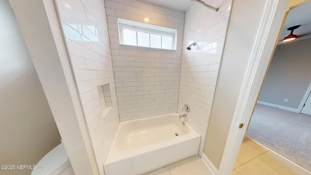 a bathroom with a bathtub a shower and a sink