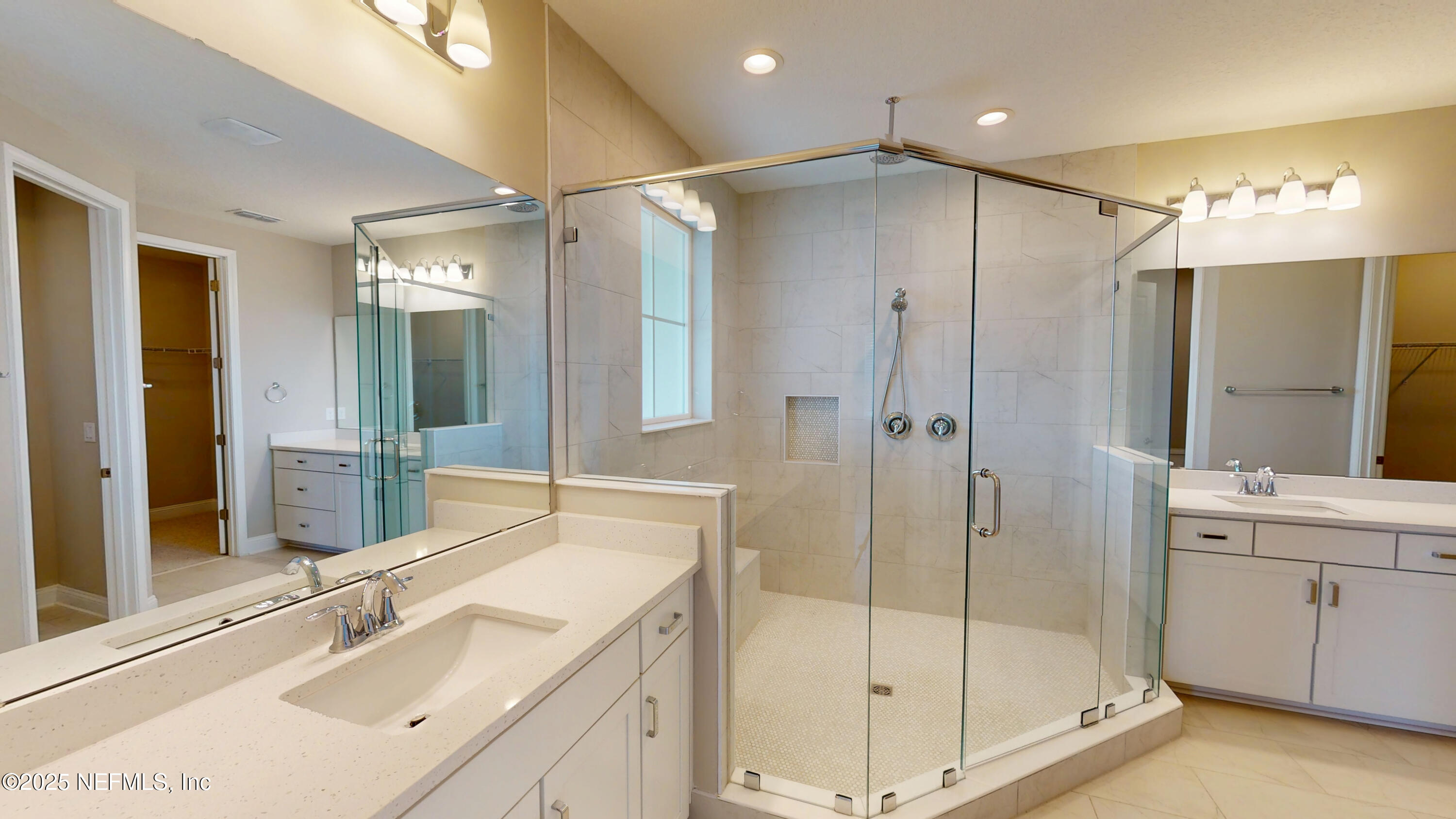511 Marquesa Circle St. Johns, FL 32259 - Photo 26 of 44 a bathroom with a shower sink large mirror and cabinets