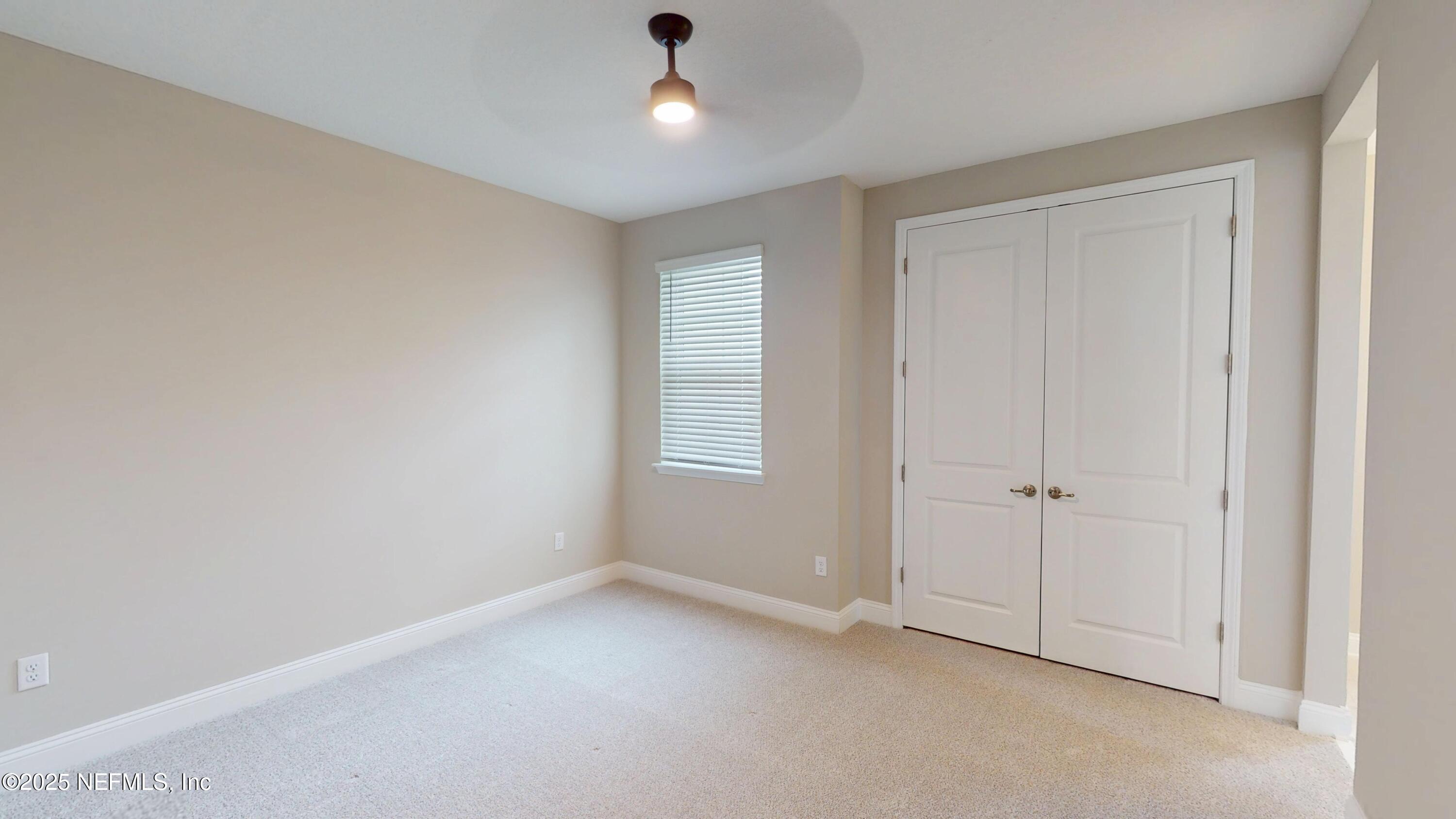 511 Marquesa Circle St. Johns, FL 32259 - Photo 29 of 44 an empty room with a ceiling fan and a window