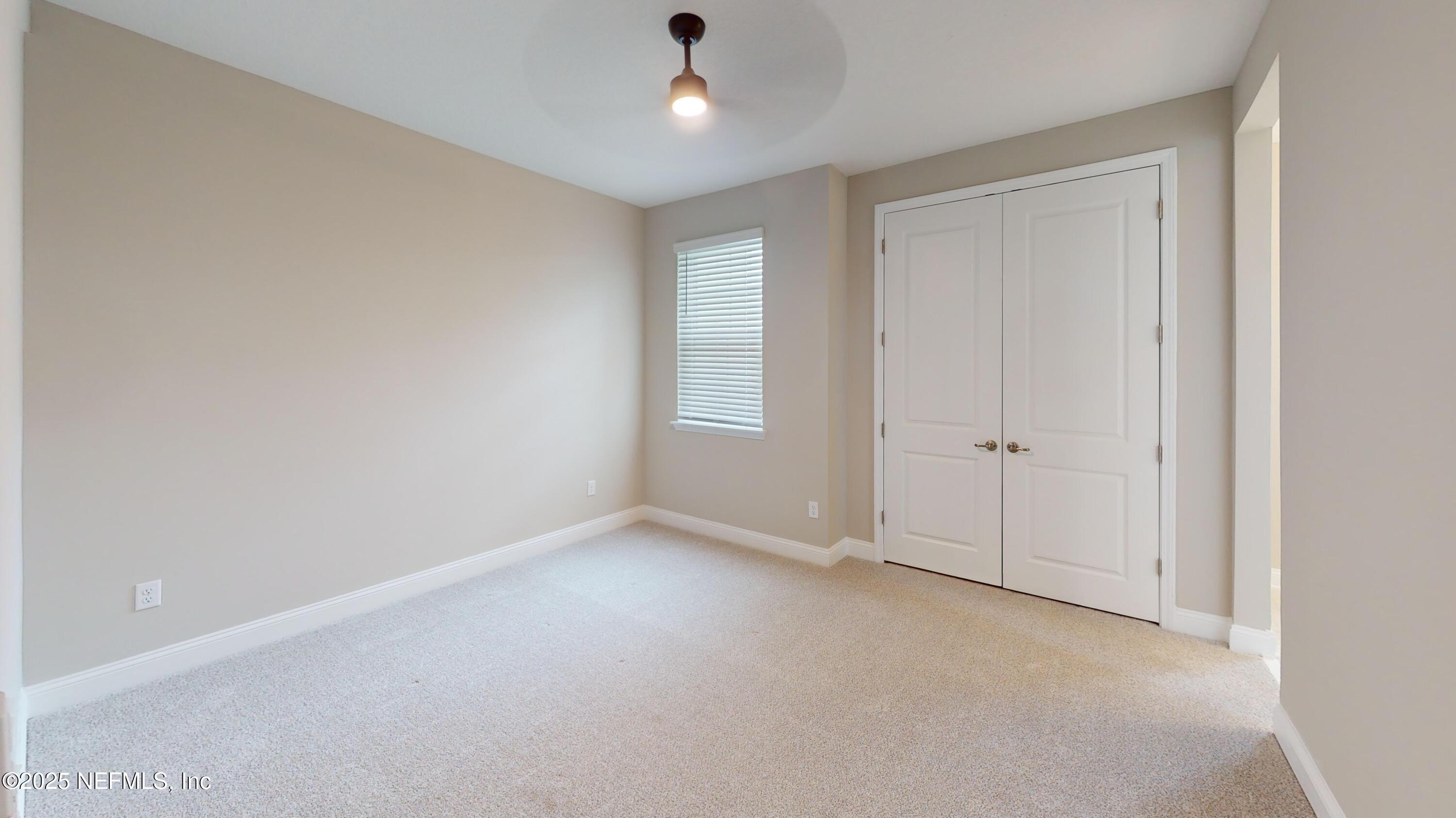 511 Marquesa Circle St. Johns, FL 32259 - Photo 31 of 44 an empty room with chandelier fan and windows