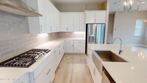 a kitchen with a sink and refrigerator