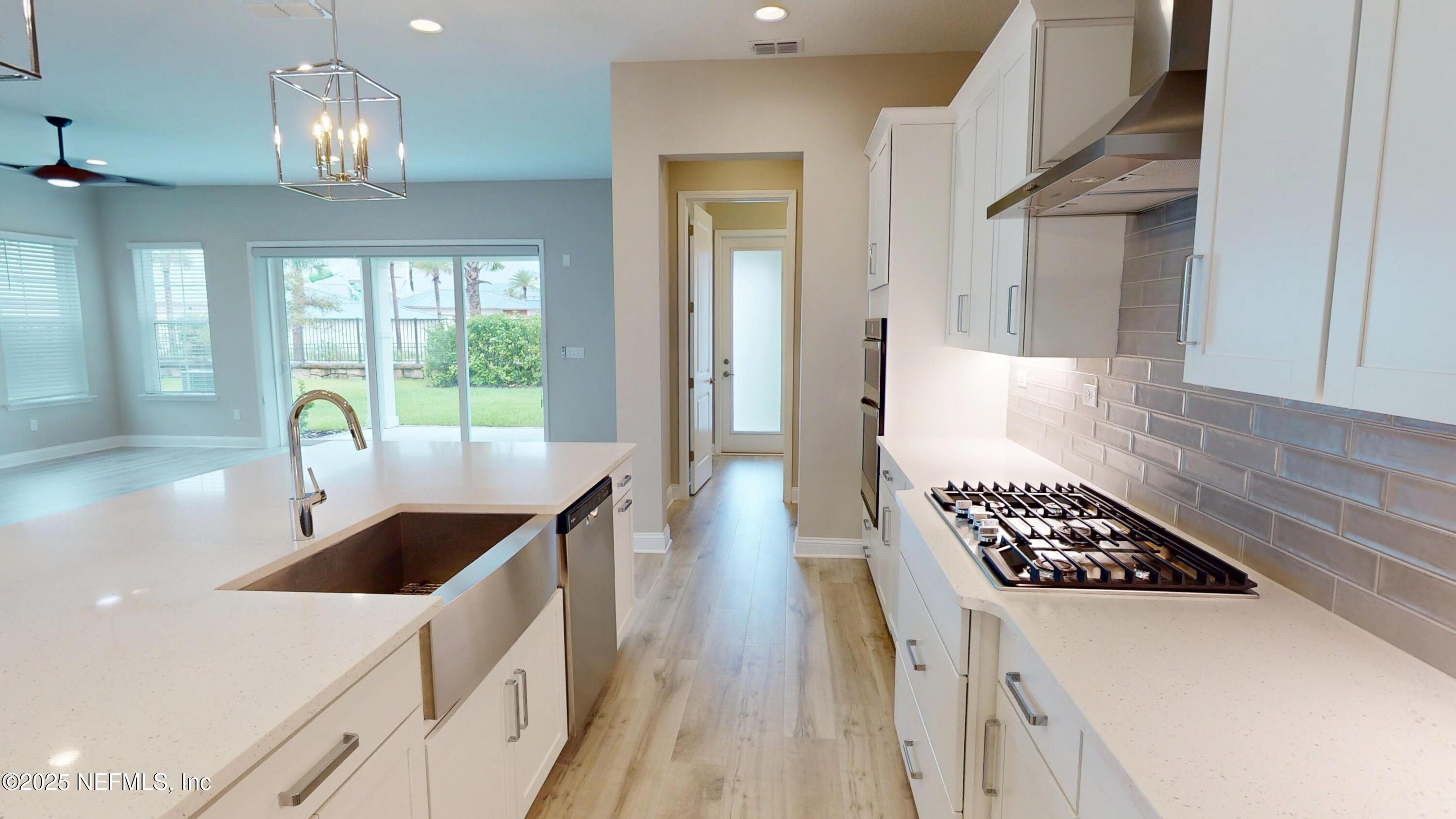 511 Marquesa Circle St. Johns, FL 32259 - Photo 5 of 44 a kitchen with stainless steel appliances a sink a stove and chairs