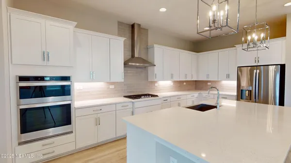 a kitchen with cabinets and stainless steel appliances