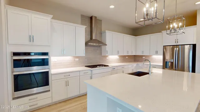 a kitchen with cabinets and stainless steel appliances
