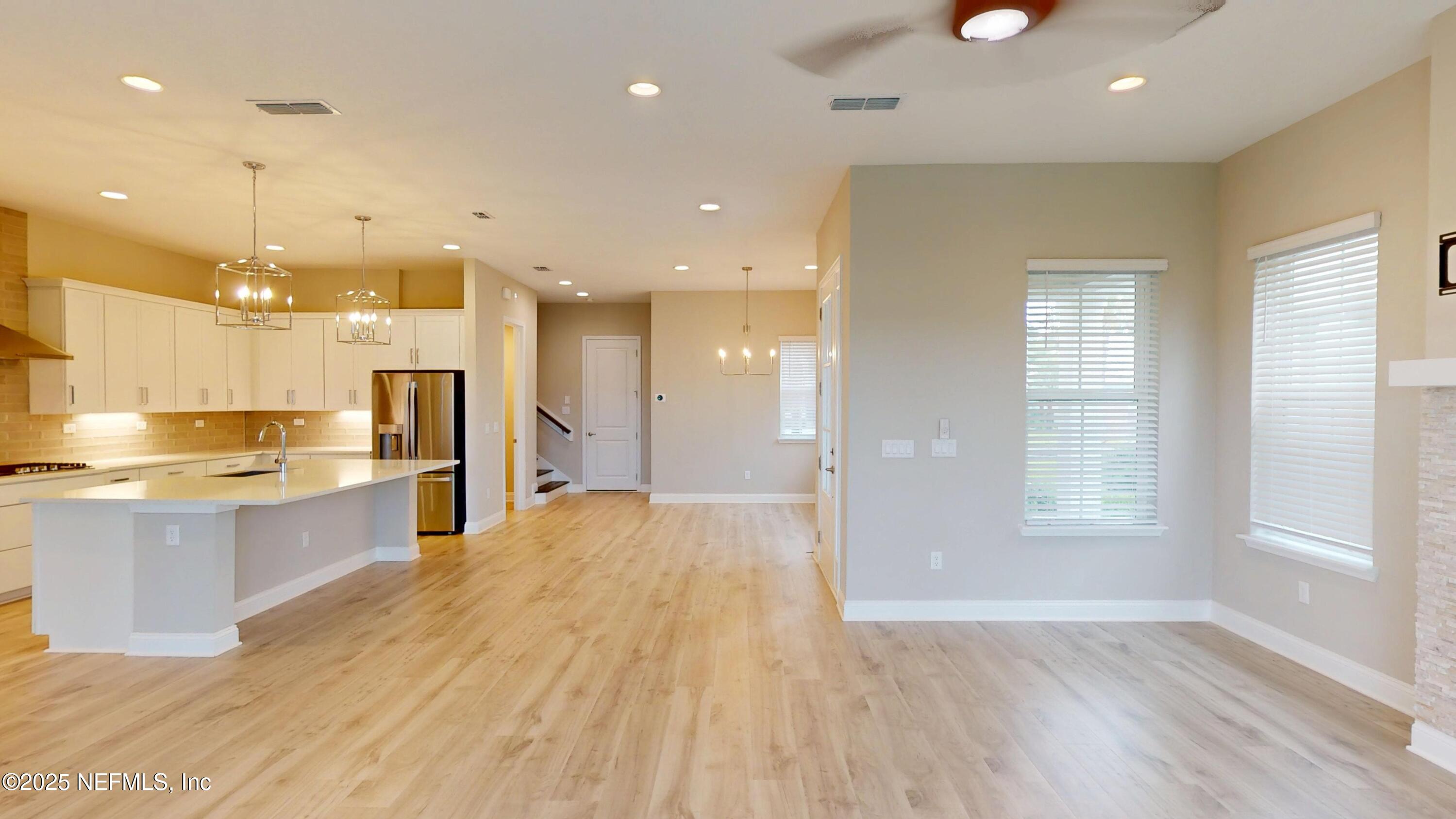 511 Marquesa Circle St. Johns, FL 32259 - Photo 8 of 44 a large kitchen with stainless steel appliances kitchen island a large counter top and a wooden floors