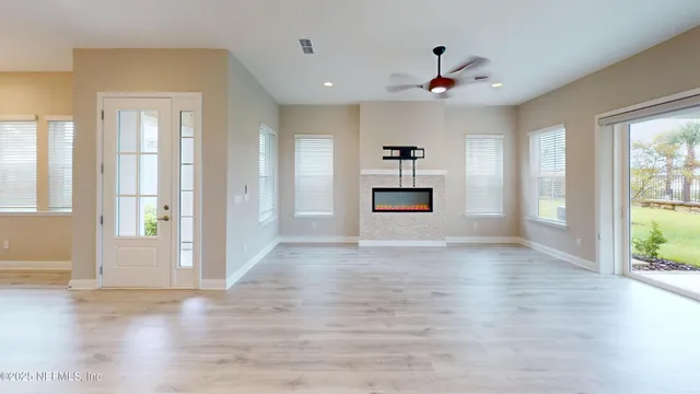 a view of a hallway with wooden floor and a cabinet