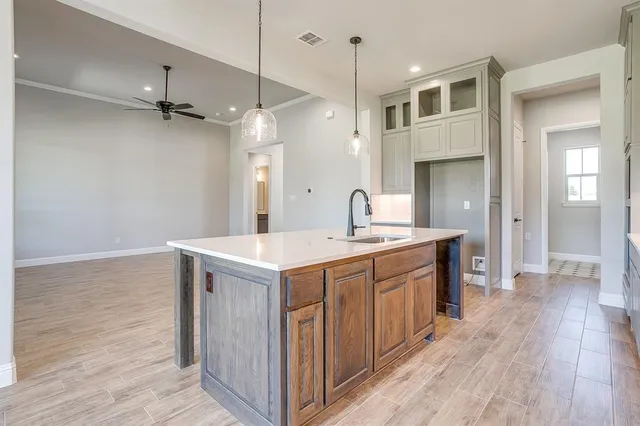 a kitchen with a sink a counter top space a sink and a refrigerator