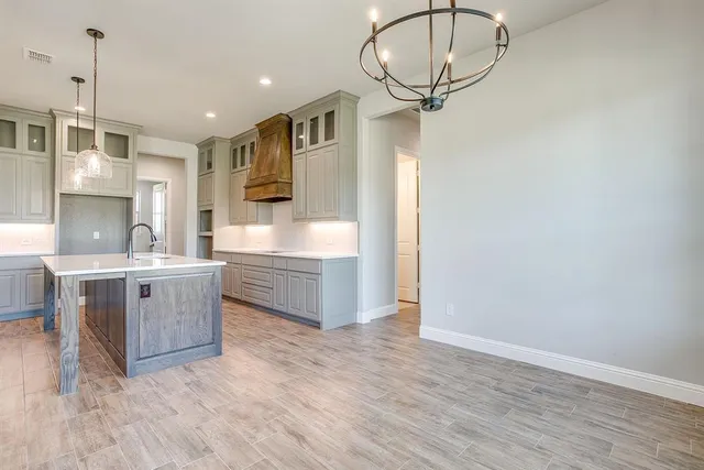 a kitchen with kitchen island a sink stainless steel appliances and cabinets