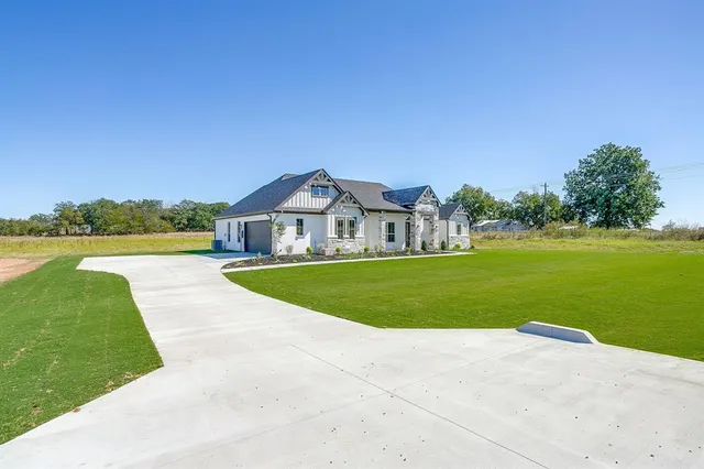 a view of house with swimming pool and yard