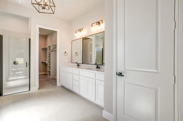 a bathroom with a double vanity sink and mirror